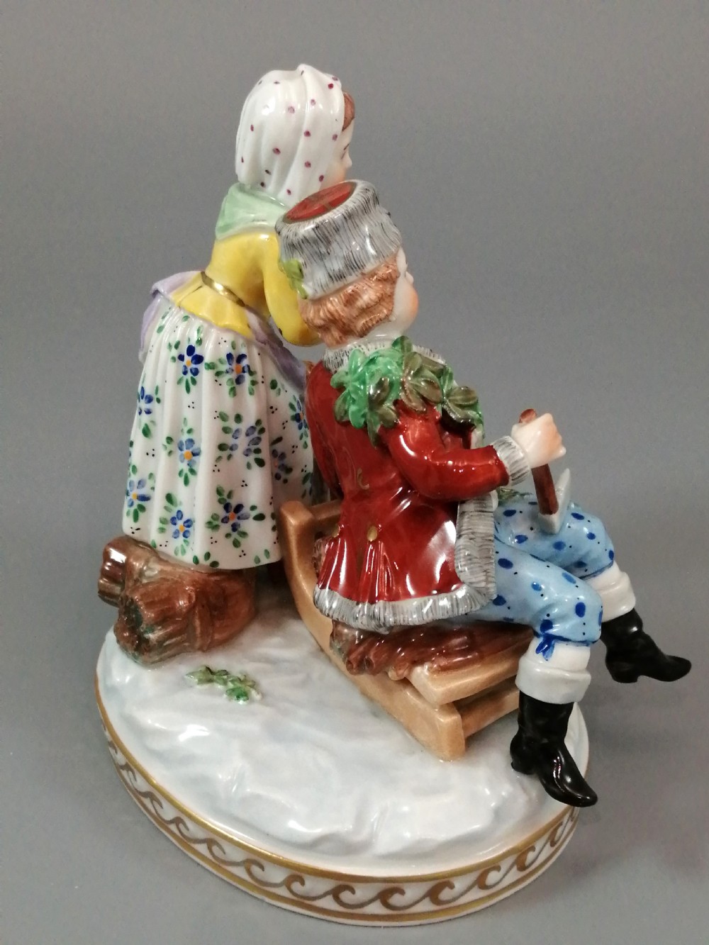 A Carl Thieme Potschappel hand-painted porcelain figurine depicting a young couple in eighteenth-century winter costume beside a sledge and brazier. View V