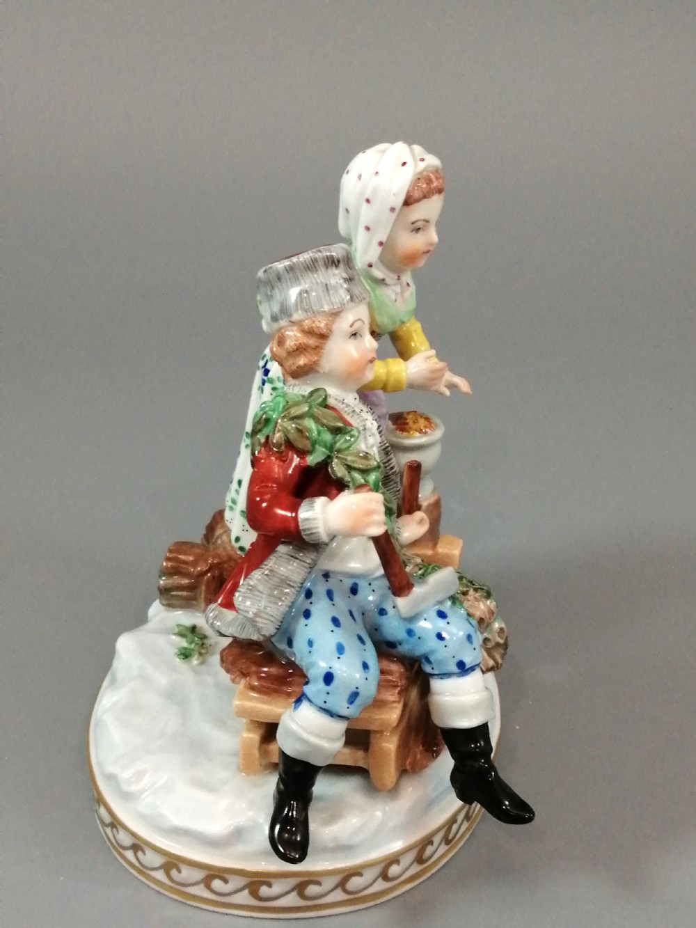 A Carl Thieme Potschappel hand-painted porcelain figurine depicting a young couple in eighteenth-century winter costume beside a sledge and brazier. View VI
