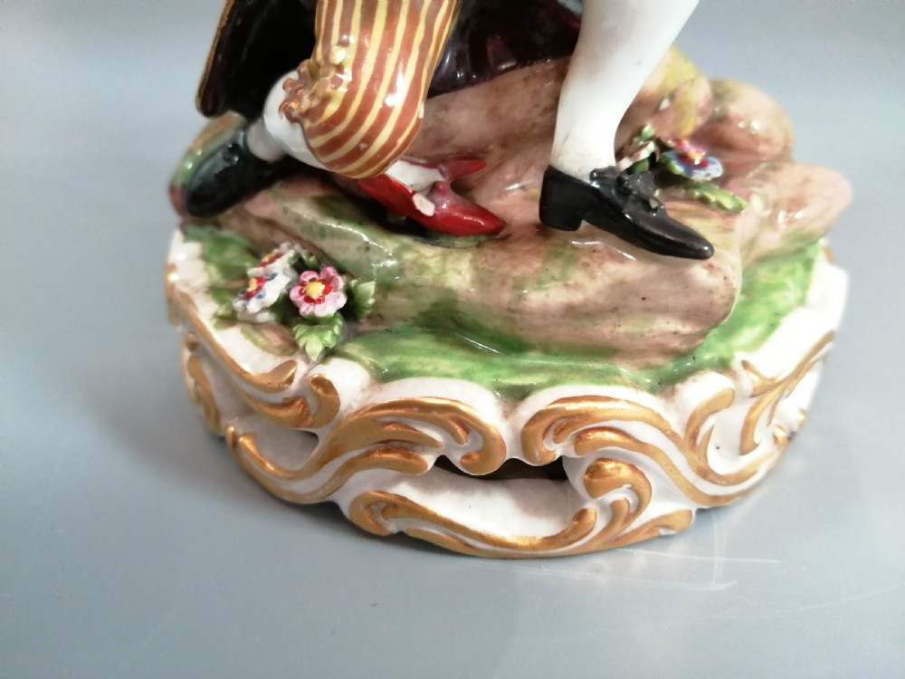 Early 19th-century Derby porcelain figural group depicting a shoemaker and a standing lady beside a tree on a gilded scroll base. View XI