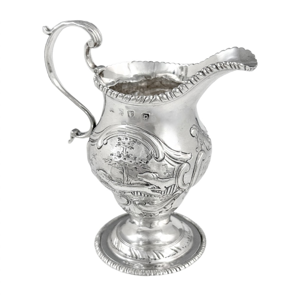 Antique George III sterling silver milk jug on pedestal foot with hunting scenes, Walter Brind, 1770