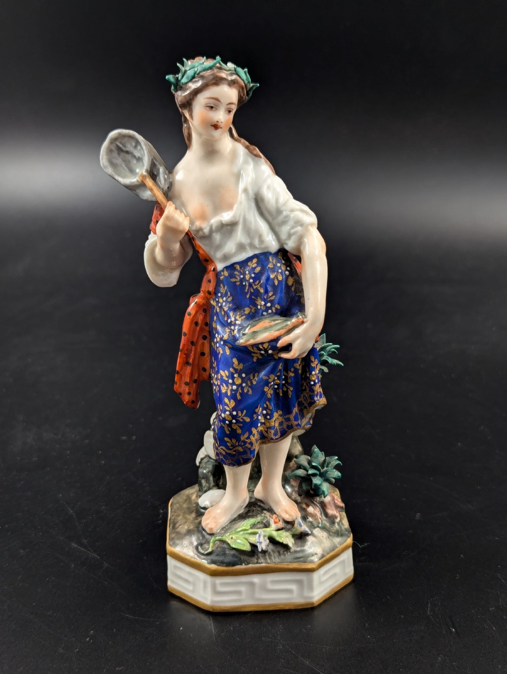 An antique hand-painted Derby porcelain figurine depicting an allegory of water on a moulded base.