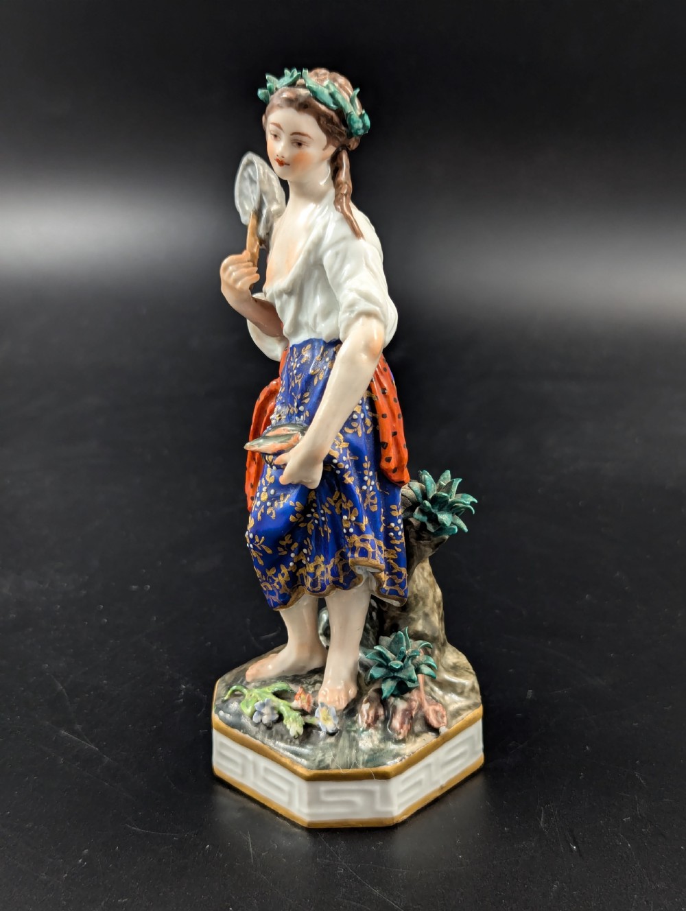 An antique hand-painted Derby porcelain figurine depicting an allegory of water on a moulded base. View II