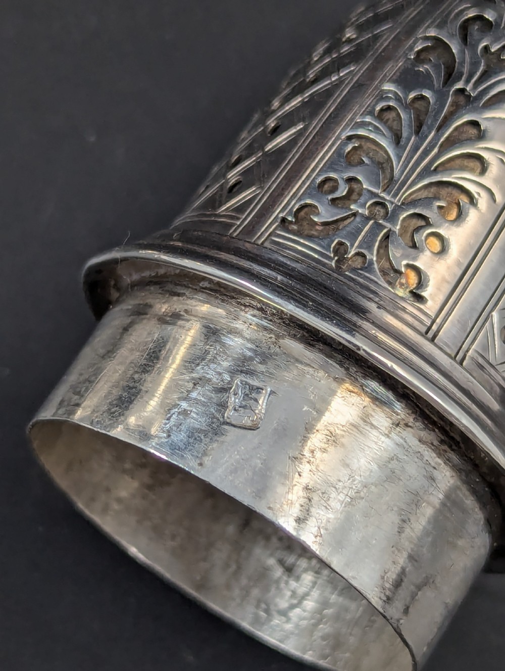 A pair of George II sterling silver baluster-form casters featuring pierced lattice tops, chased scroll detailing, and stepped pedestal bases. View XIV
