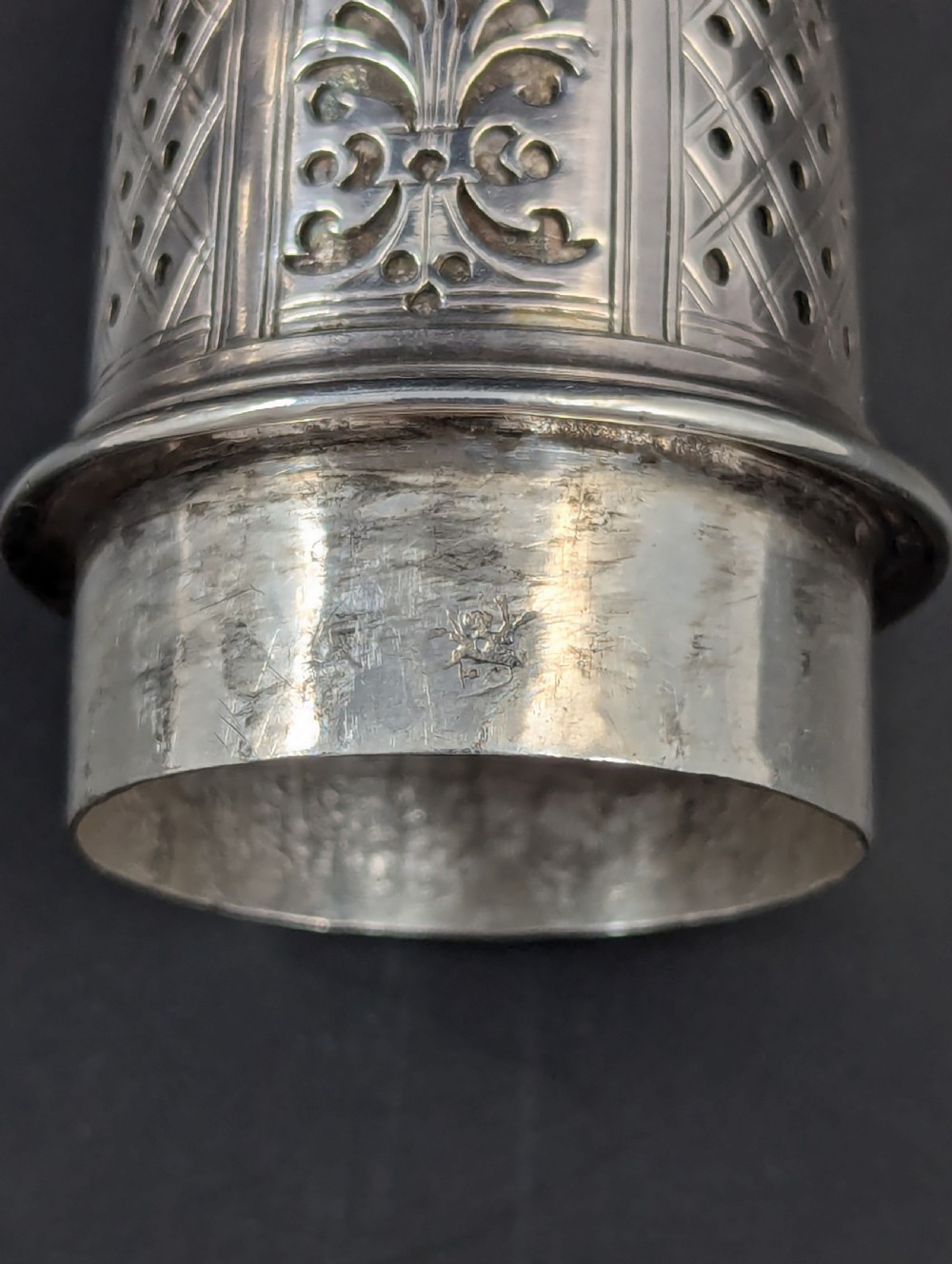 A pair of George II sterling silver baluster-form casters featuring pierced lattice tops, chased scroll detailing, and stepped pedestal bases. View XV
