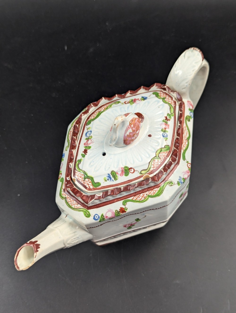 An octagonal off-white antique pearlware teapot decorated with hand-painted floral sprigs, a fluted base, and a swan-form lid knop. View XIV