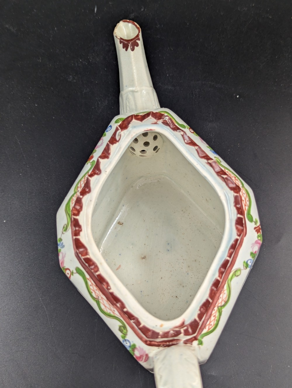 An octagonal off-white antique pearlware teapot decorated with hand-painted floral sprigs, a fluted base, and a swan-form lid knop. View XVI