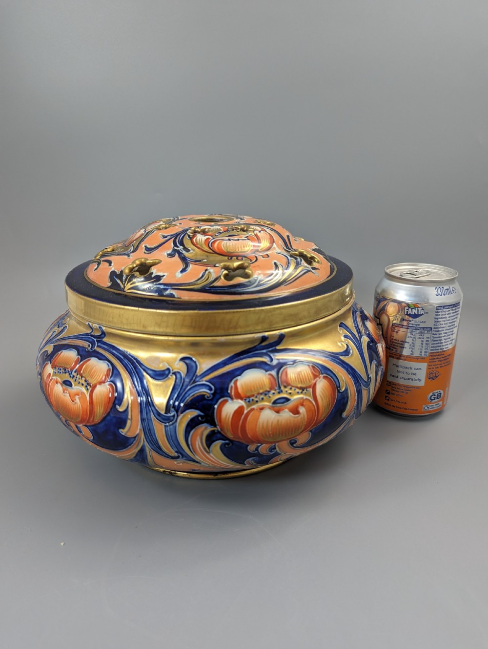 An Edwardian Moorcroft Macintyre ceramic pot pourri jar with a pierced lid, featuring hand-painted tube-lined floral decoration in cobalt blue, coral, and gold. View XIII