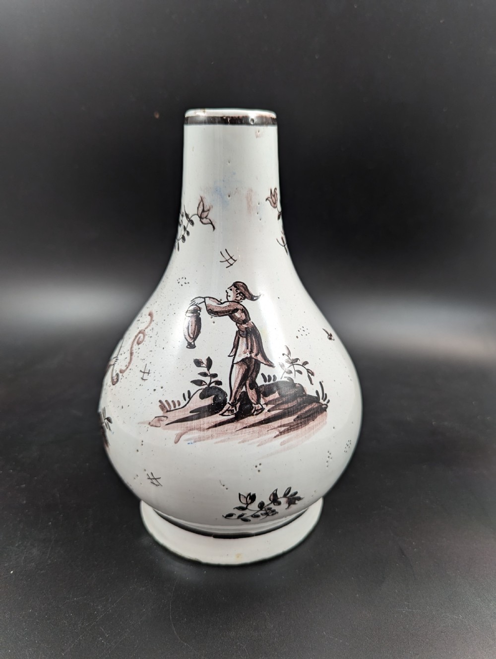 A mid-18th-century tin-glazed earthenware vase with a pear-shaped body, decorated with hand-painted manganese Chinoiserie figures. View III