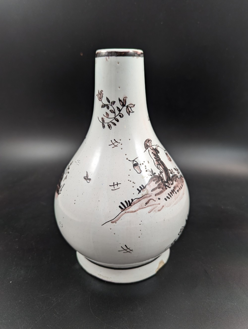 A mid-18th-century tin-glazed earthenware vase with a pear-shaped body, decorated with hand-painted manganese Chinoiserie figures. View V