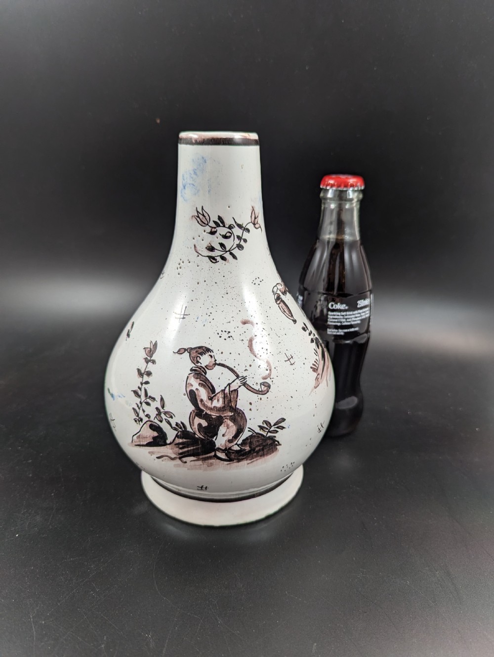 A mid-18th-century tin-glazed earthenware vase with a pear-shaped body, decorated with hand-painted manganese Chinoiserie figures. View IX