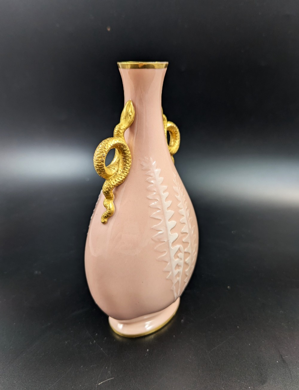 A blush pink porcelain vase featuring white pate-sur-pate fern foliage decoration and two gilded serpent handles. View III