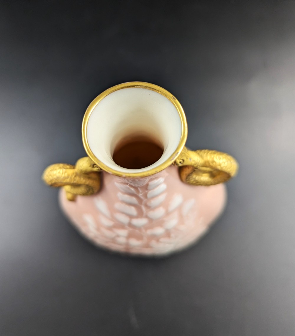 A blush pink porcelain vase featuring white pate-sur-pate fern foliage decoration and two gilded serpent handles. View VIII