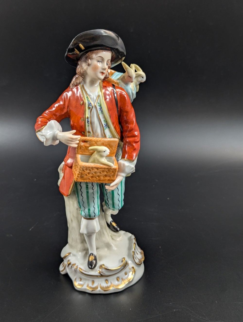 Lovely early 20th century Sitzendorf porcelain figurine of a young rabbit seller. View V