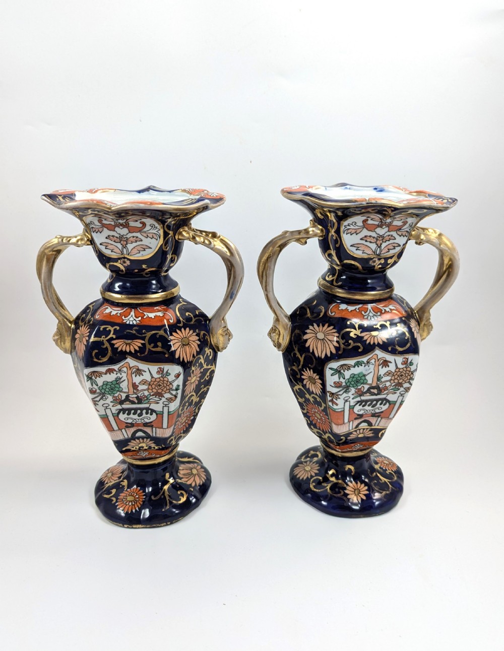 A pair of antique Masons ironstone vases decorated in a cobalt blue and terracotta Imari pattern with double gilt handles. View III