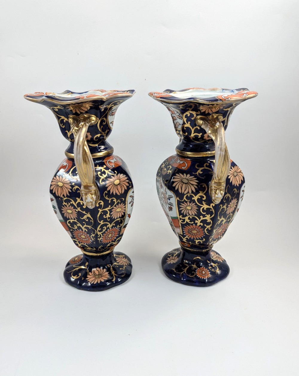 A pair of antique Masons ironstone vases decorated in a cobalt blue and terracotta Imari pattern with double gilt handles. View IV