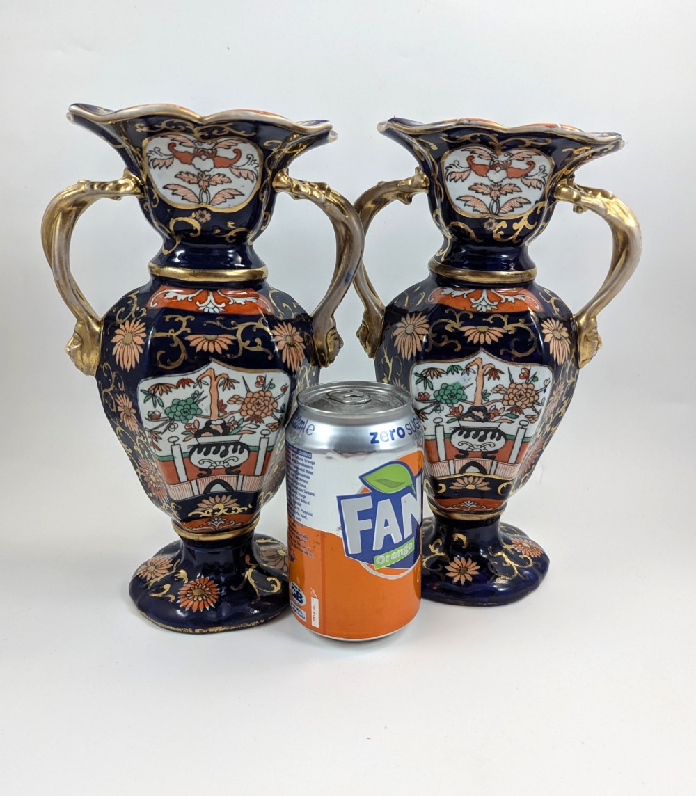 A pair of antique Masons ironstone vases decorated in a cobalt blue and terracotta Imari pattern with double gilt handles. View VII
