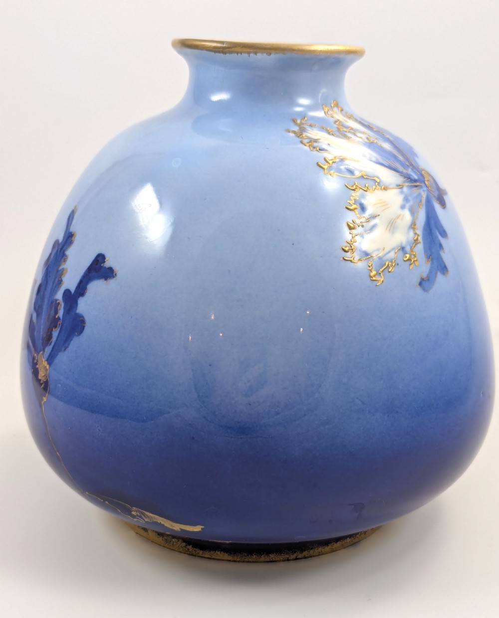 A bulbous Art Nouveau porcelain vase featuring a blue gradient backdrop decorated with hand-painted white chrysanthemums and gold gilt highlights. View IV