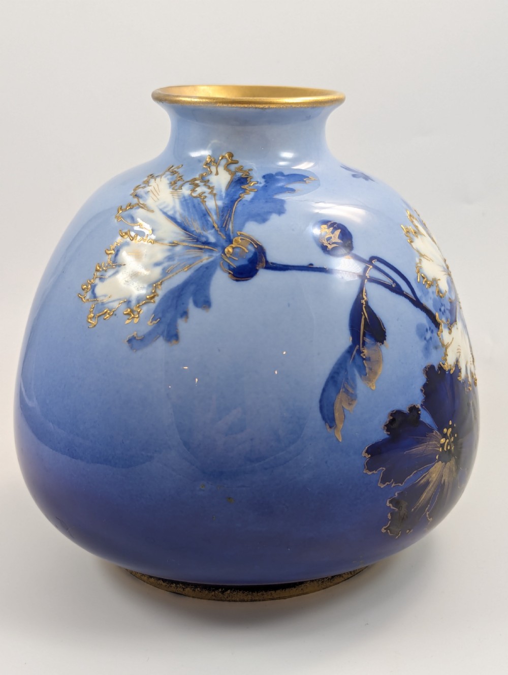 A bulbous Art Nouveau porcelain vase featuring a blue gradient backdrop decorated with hand-painted white chrysanthemums and gold gilt highlights. View V
