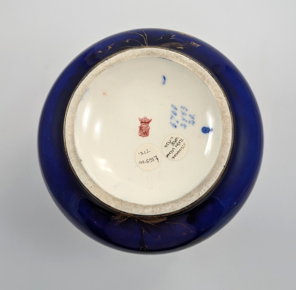 A bulbous Art Nouveau porcelain vase featuring a blue gradient backdrop decorated with hand-painted white chrysanthemums and gold gilt highlights. View VIII