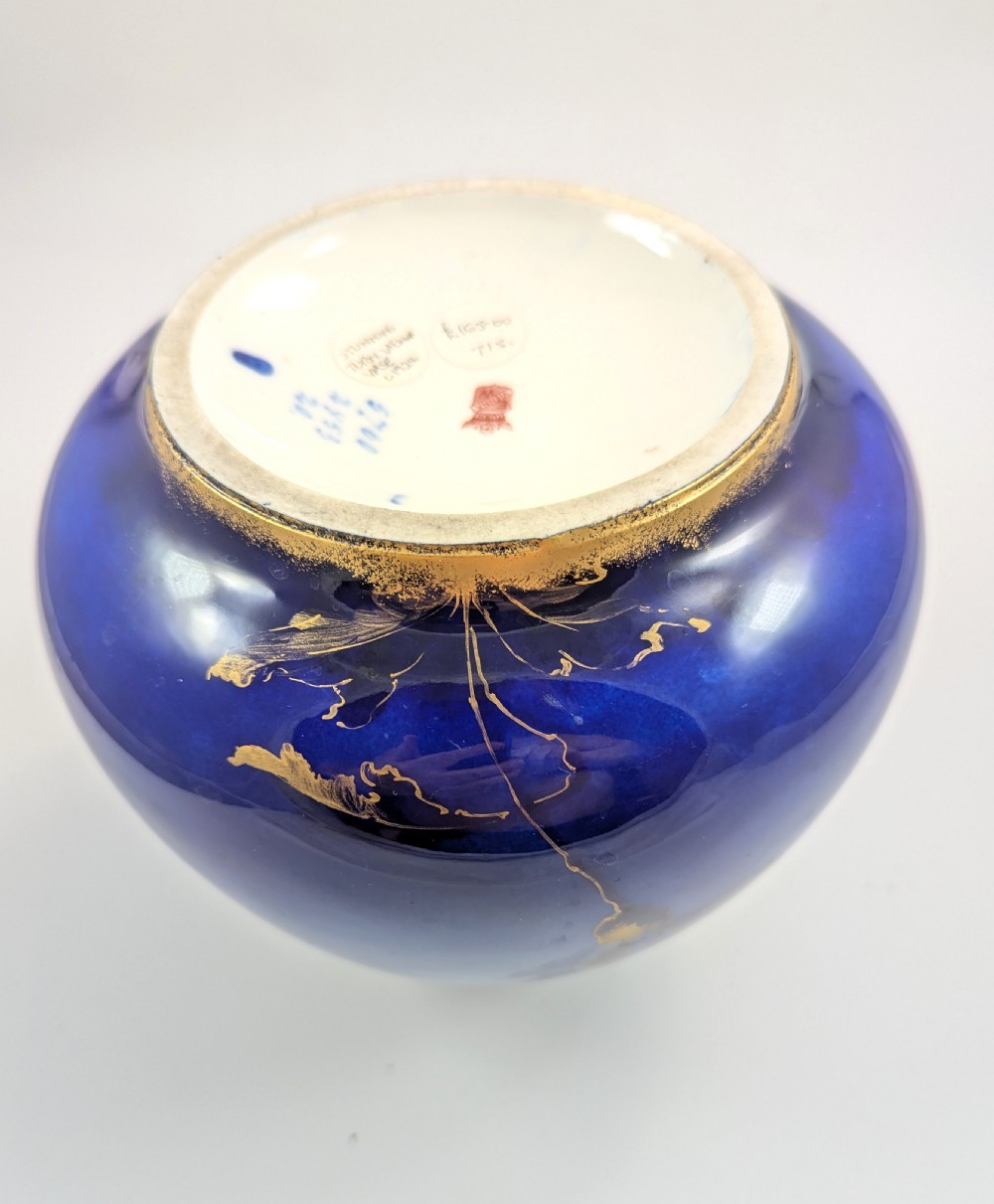 A bulbous Art Nouveau porcelain vase featuring a blue gradient backdrop decorated with hand-painted white chrysanthemums and gold gilt highlights. View IX