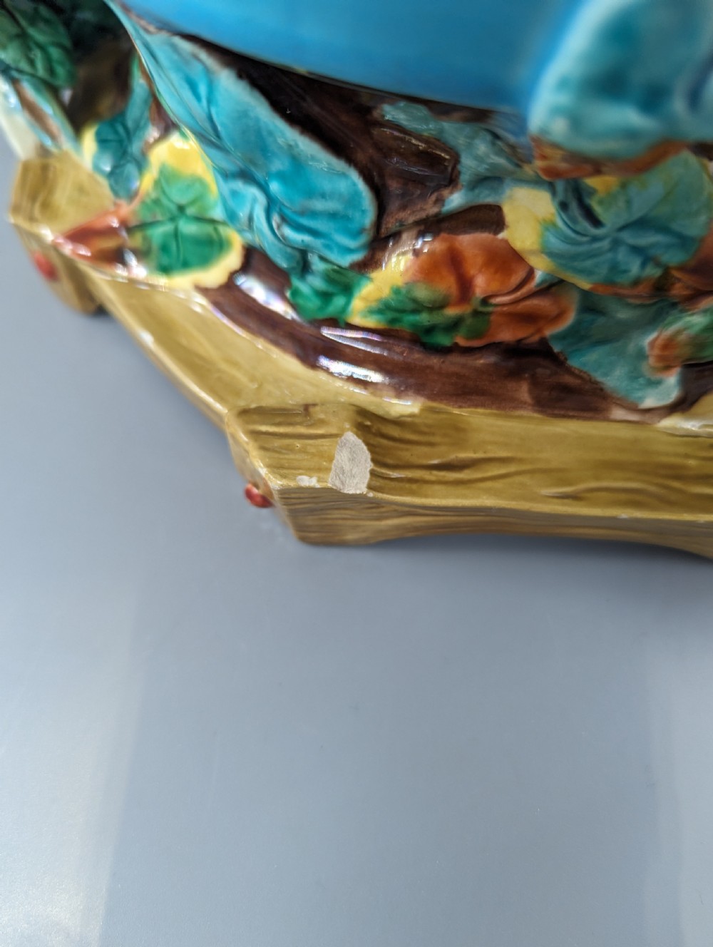 A Victorian Royal Worcester turquoise majolica jardiniere planter featuring relief-moulded foliage and a faux-woodland base. View VI