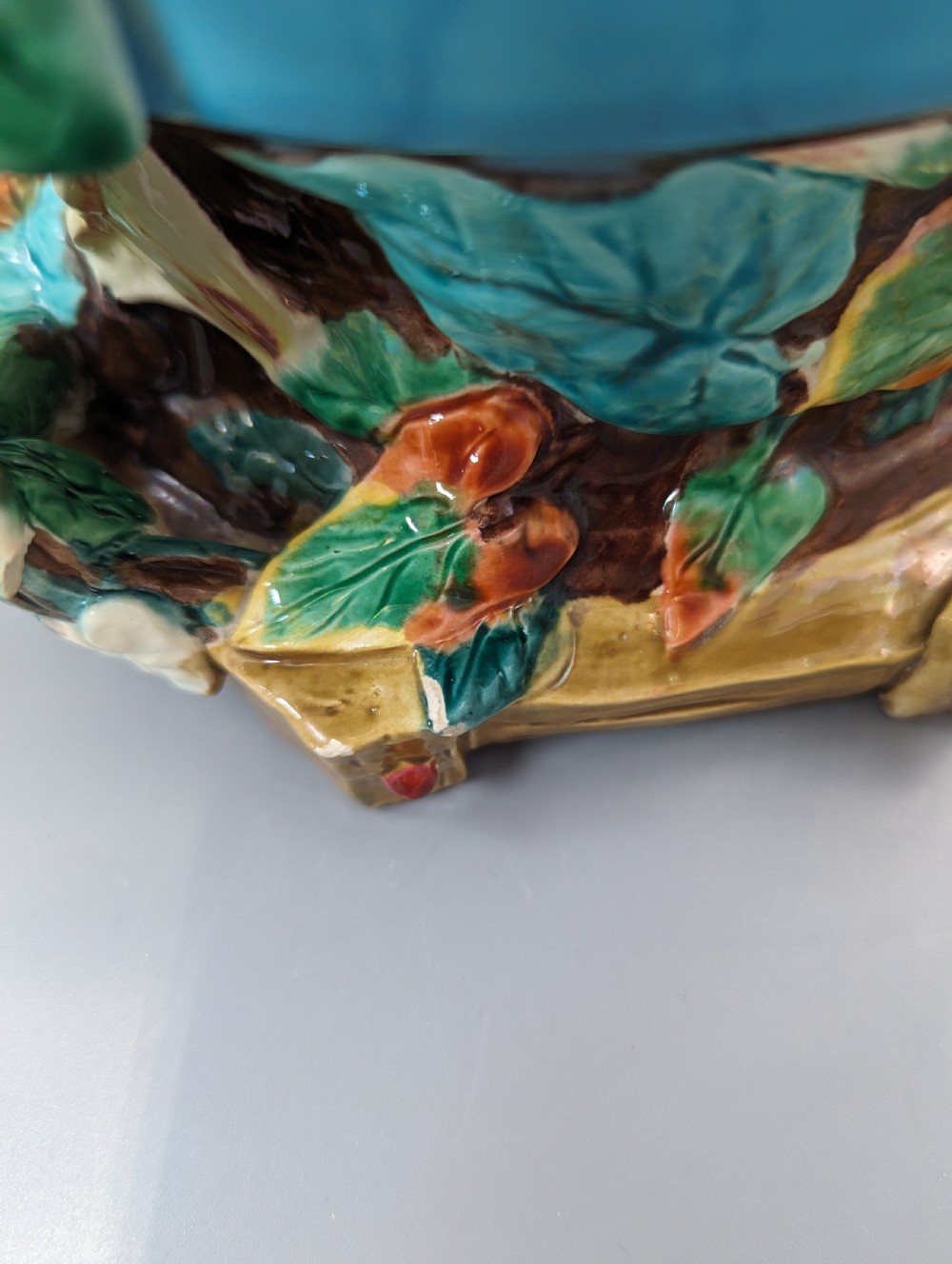 A Victorian Royal Worcester turquoise majolica jardiniere planter featuring relief-moulded foliage and a faux-woodland base. View VIII