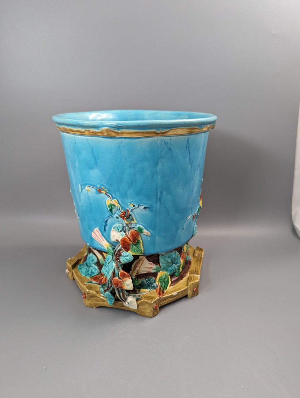A Victorian Royal Worcester turquoise majolica jardiniere planter featuring relief-moulded foliage and a faux-woodland base. View XIV