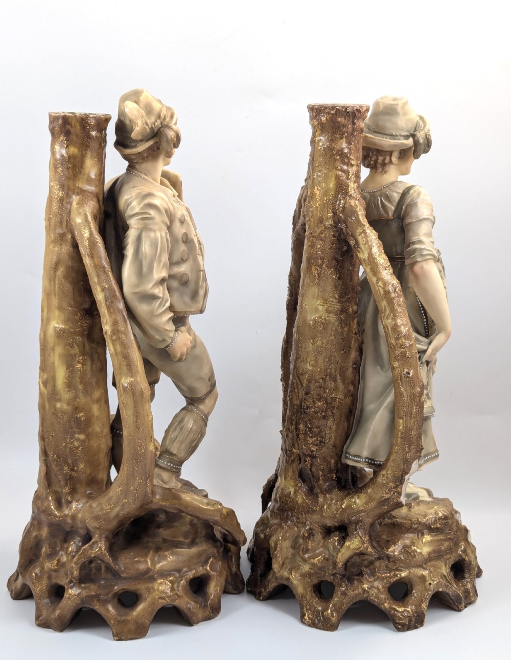 A pair of nineteenth-century Bohemian porcelain figurines depicting a man and woman in folk attire framed by gilded root-like arbours on sculpted bases. View IV