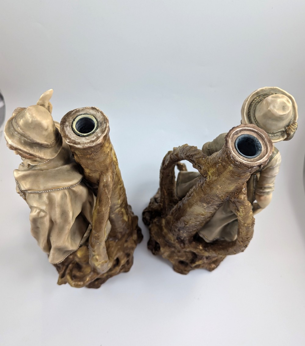 A pair of nineteenth-century Bohemian porcelain figurines depicting a man and woman in folk attire framed by gilded root-like arbours on sculpted bases. View VI