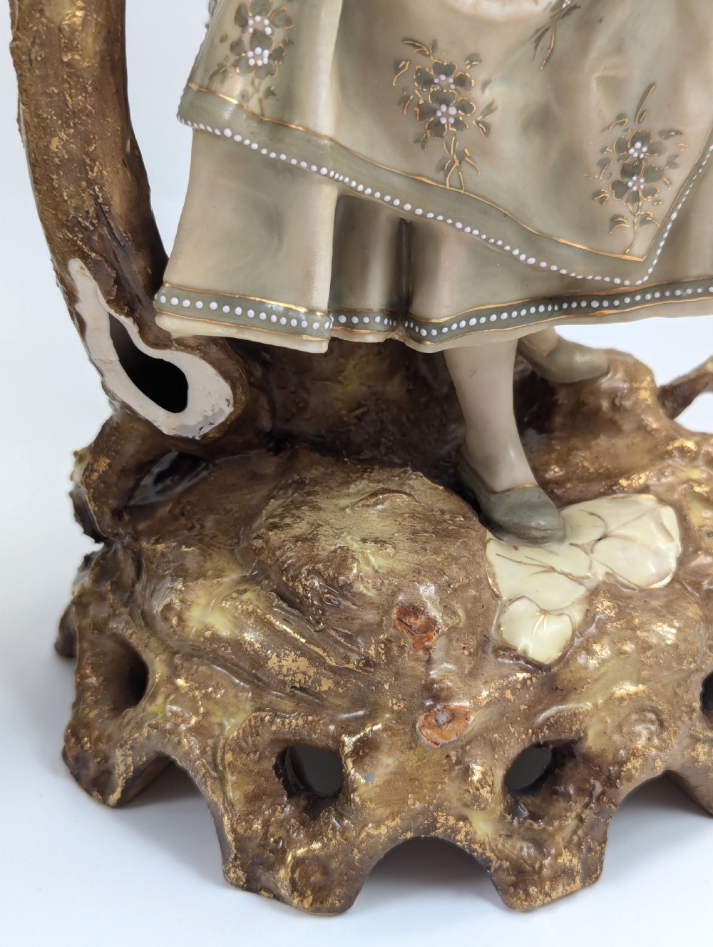 A pair of nineteenth-century Bohemian porcelain figurines depicting a man and woman in folk attire framed by gilded root-like arbours on sculpted bases. View IX