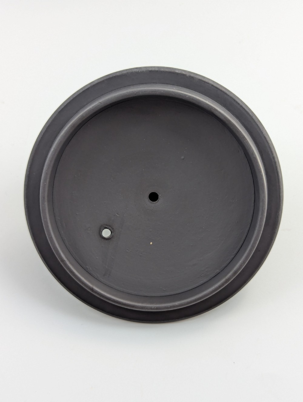 An eighteenth-century Wedgwood black basalt teapot featuring a ribbed stoneware body, high loop handle, and a seated female figure finial on the lid. View XII