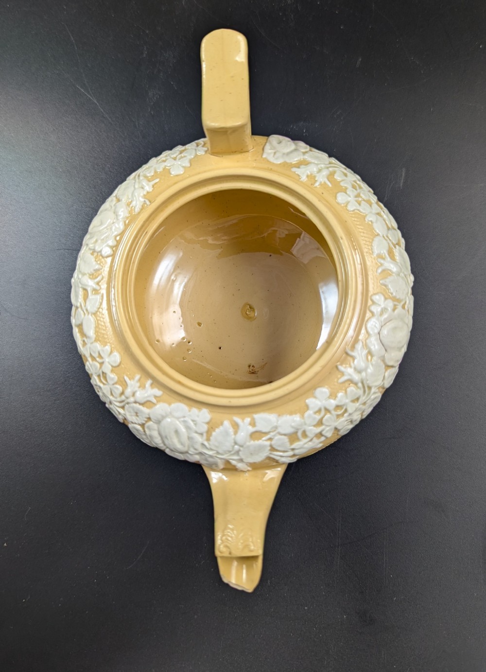 A Regency period buff stoneware teapot and matching creamer jug featuring engine-turned lattice patterning and applied white botanical reliefs. View VIII