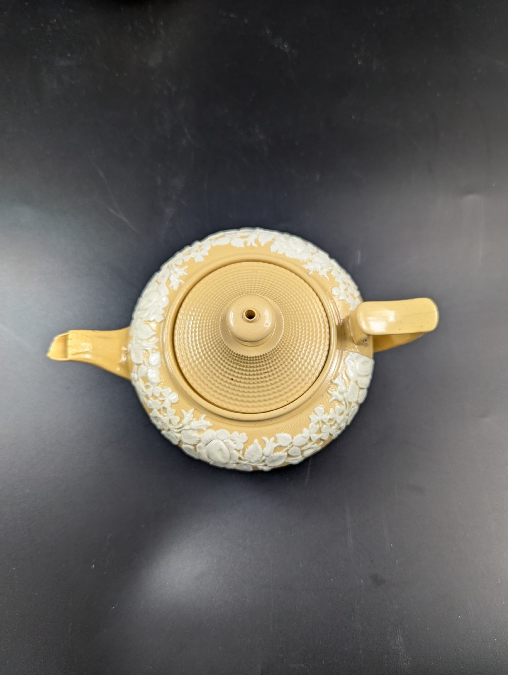 A Regency period buff stoneware teapot and matching creamer jug featuring engine-turned lattice patterning and applied white botanical reliefs. View XI