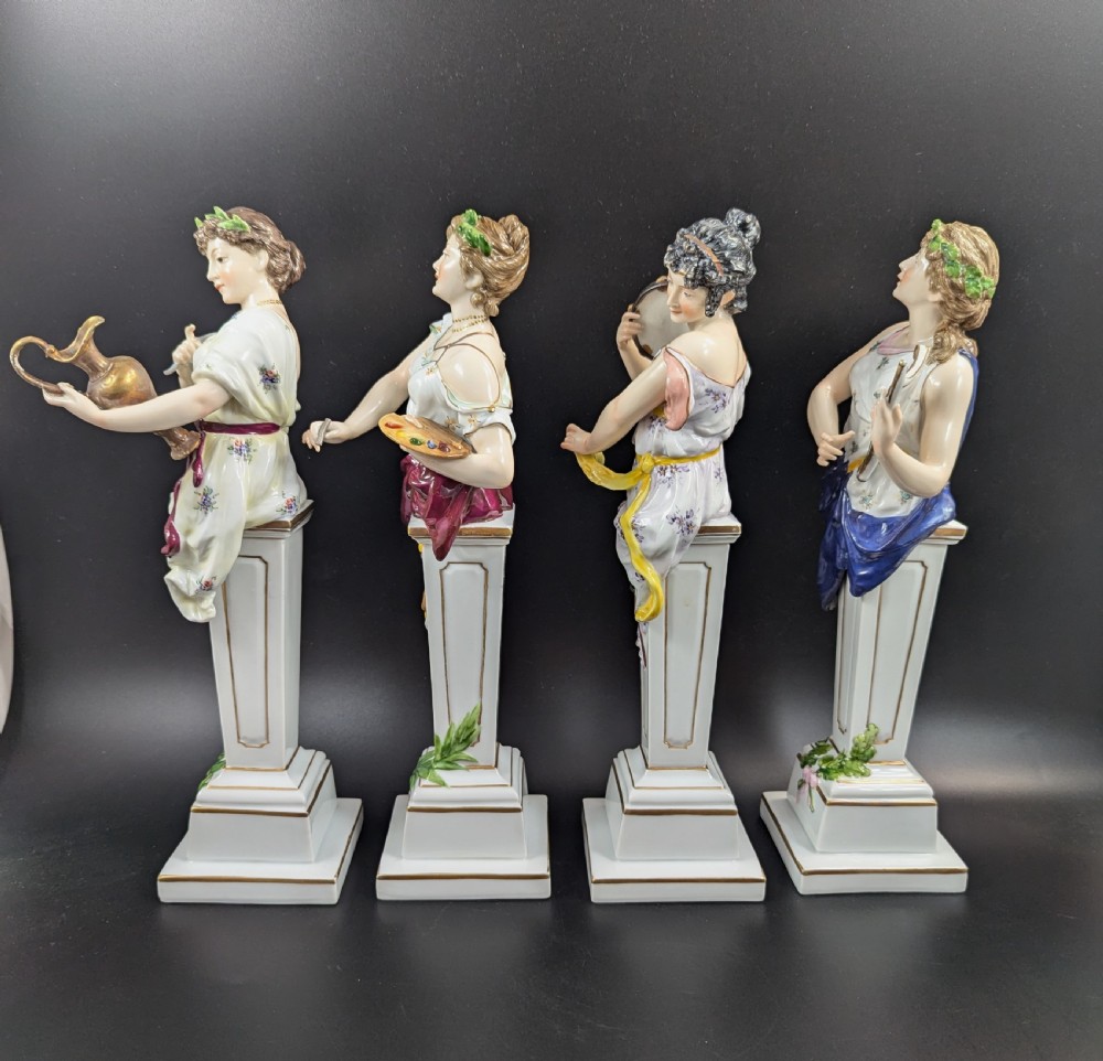A set of four 19th-century glazed Italian porcelain figurines depicting allegorical female figures representing the arts atop gilded square pedestals. View II