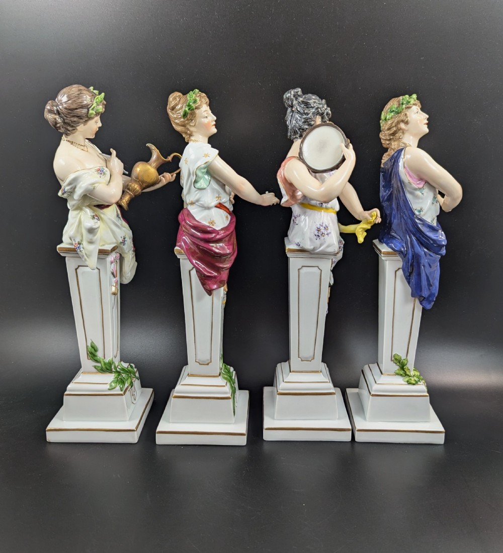 A set of four 19th-century glazed Italian porcelain figurines depicting allegorical female figures representing the arts atop gilded square pedestals. View V