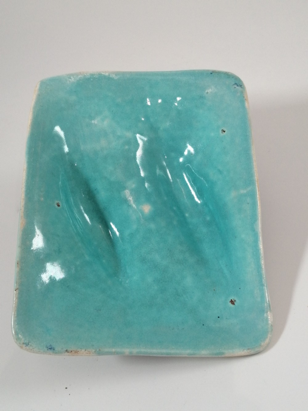 A rectangular Victorian majolica sardine box with matching undertray featuring cobalt blue fish relief decoration on an off-white lid. View XIII
