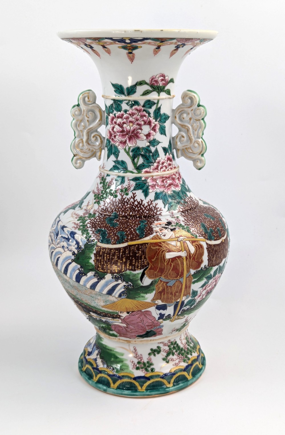 A 19th-century Japanese Kyoto Satsuma porcelain vase featuring scroll handles, a flared rim, and detailed polychrome enamel depictions of human figures and peony blossoms.