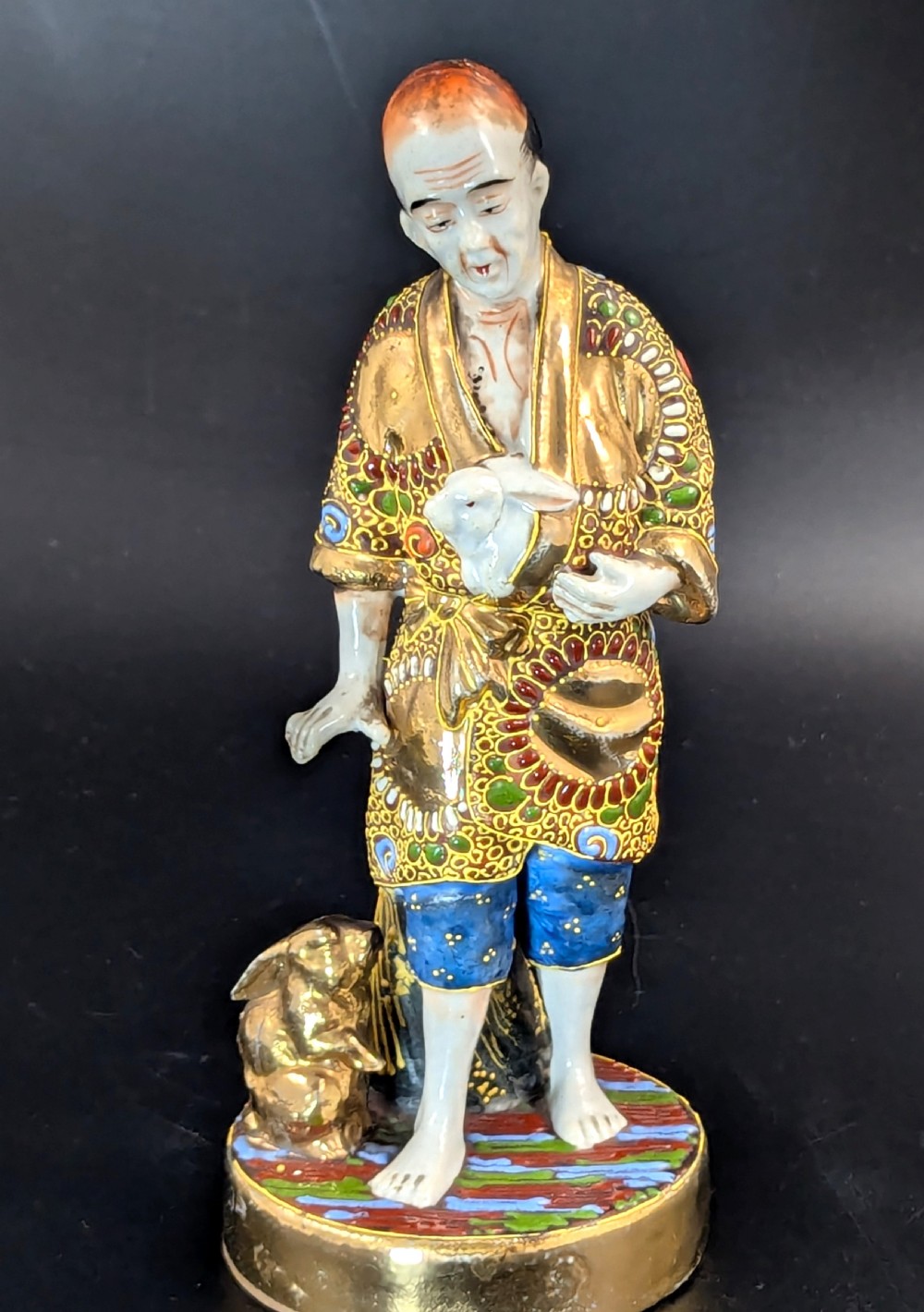 Antique Japanese Satsuma Porcelain Figurine Man with Rabbits, Meiji period (1868 -1912).