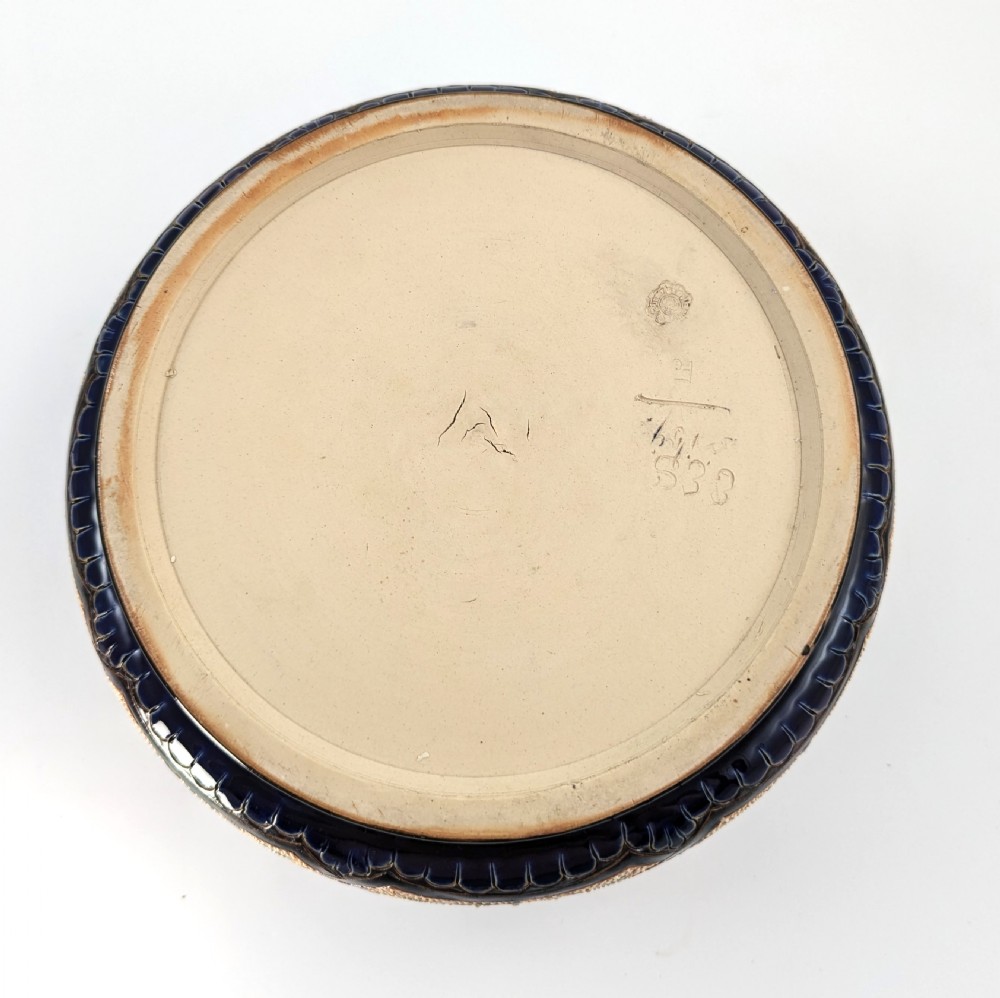 A Victorian Doulton Lambeth stoneware salad bowl decorated with cobalt blue and terracotta geometric patterns, presented with two matching ceramic-handled silver servers. View IV