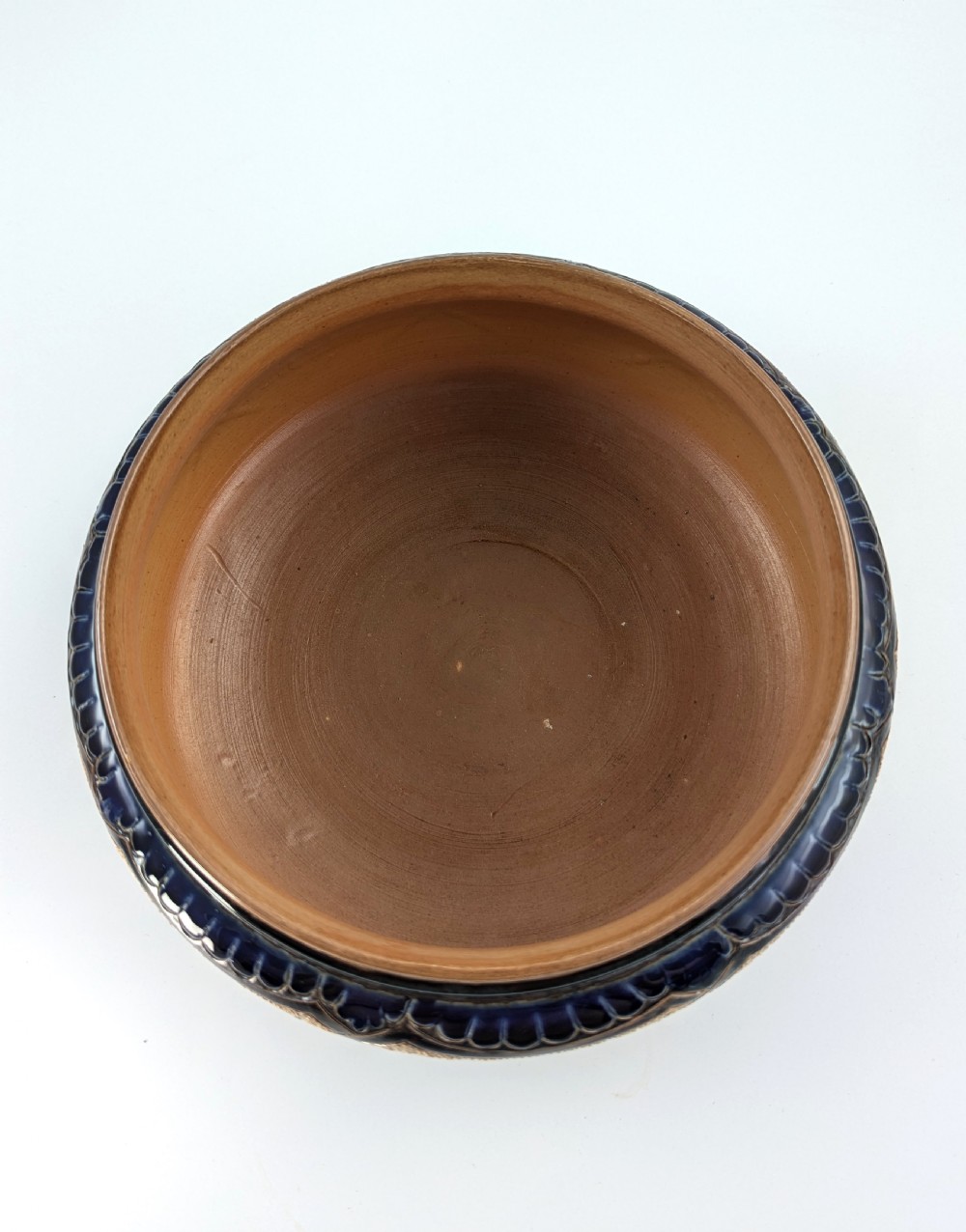 A Victorian Doulton Lambeth stoneware salad bowl decorated with cobalt blue and terracotta geometric patterns, presented with two matching ceramic-handled silver servers. View VII