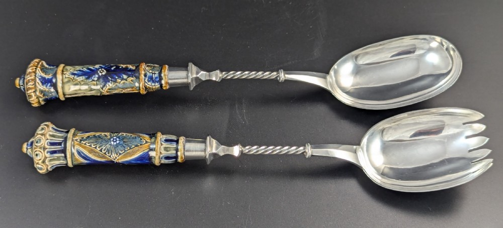 A Victorian Doulton Lambeth stoneware salad bowl decorated with cobalt blue and terracotta geometric patterns, presented with two matching ceramic-handled silver servers. View IX