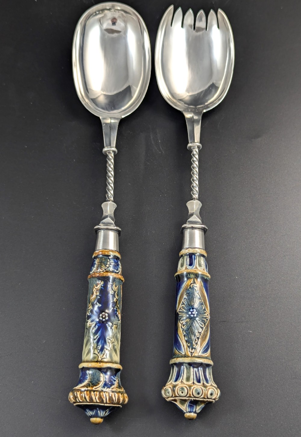 A Victorian Doulton Lambeth stoneware salad bowl decorated with cobalt blue and terracotta geometric patterns, presented with two matching ceramic-handled silver servers. View XIII