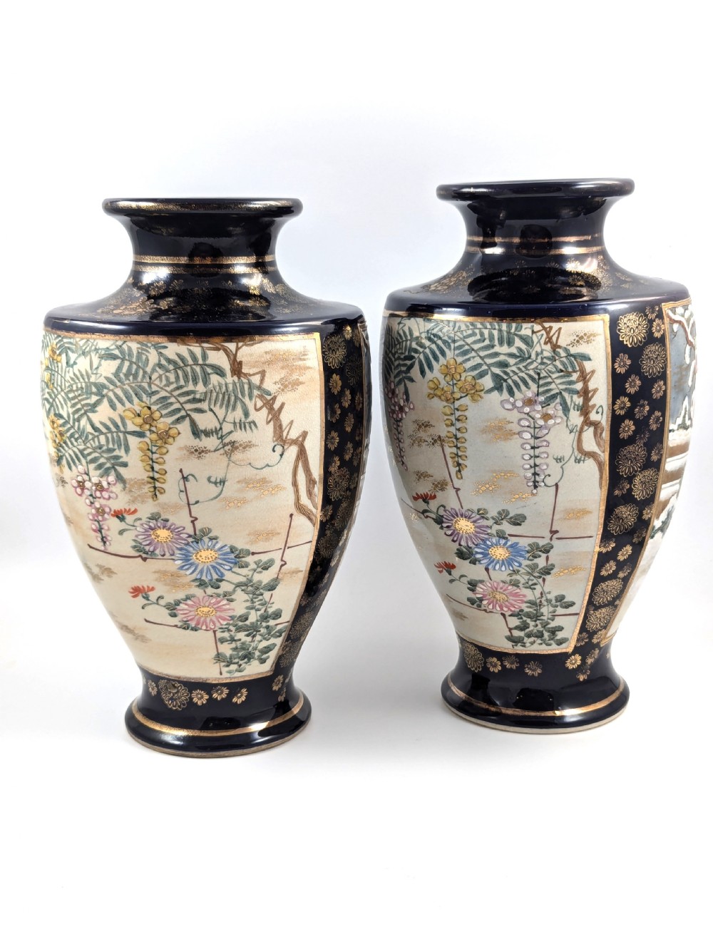 A pair of Japanese Satsuma baluster vases featuring painted figures in a snowy landscape framed by cobalt blue and gilded borders. View IV