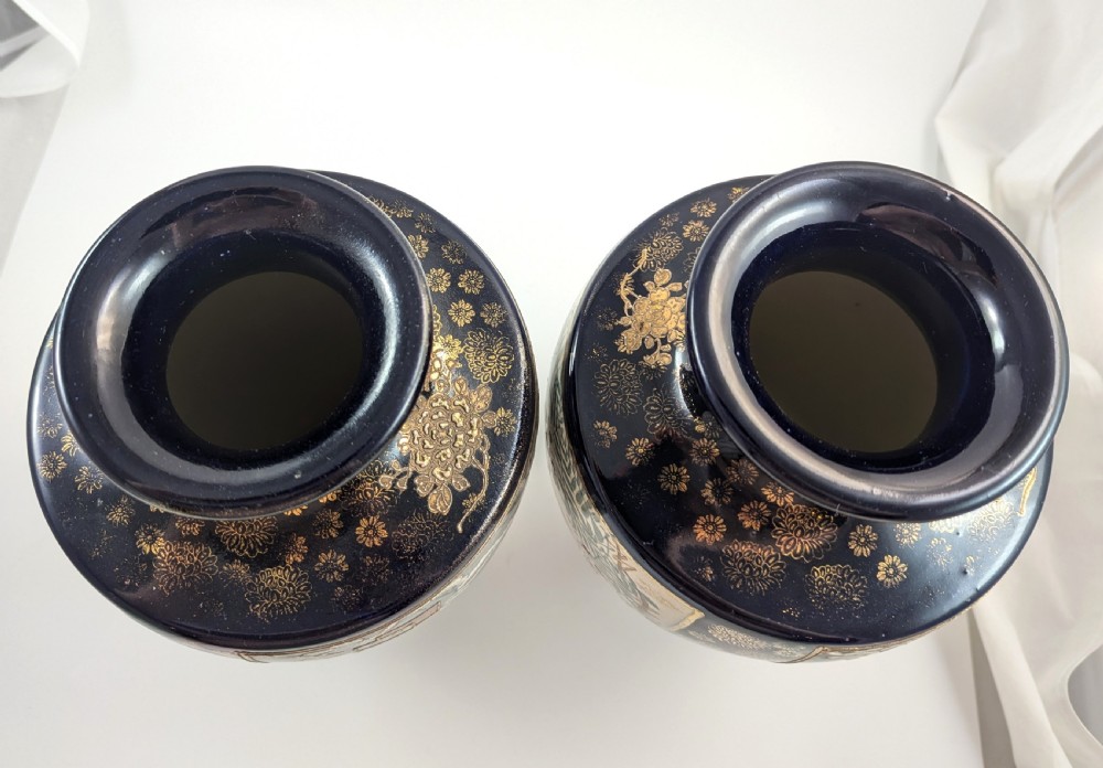 A pair of Japanese Satsuma baluster vases featuring painted figures in a snowy landscape framed by cobalt blue and gilded borders. View VI