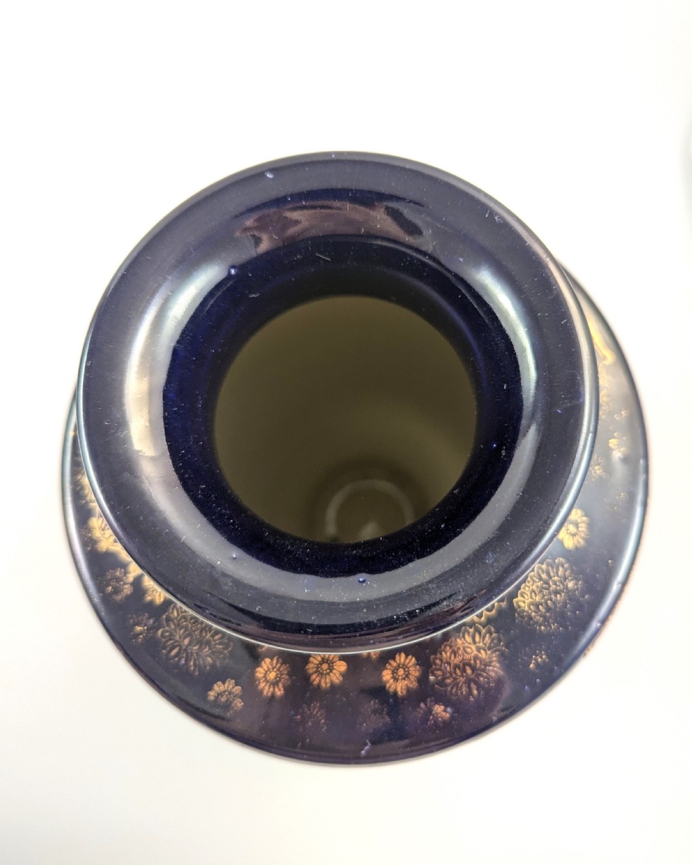 A pair of Japanese Satsuma baluster vases featuring painted figures in a snowy landscape framed by cobalt blue and gilded borders. View IX