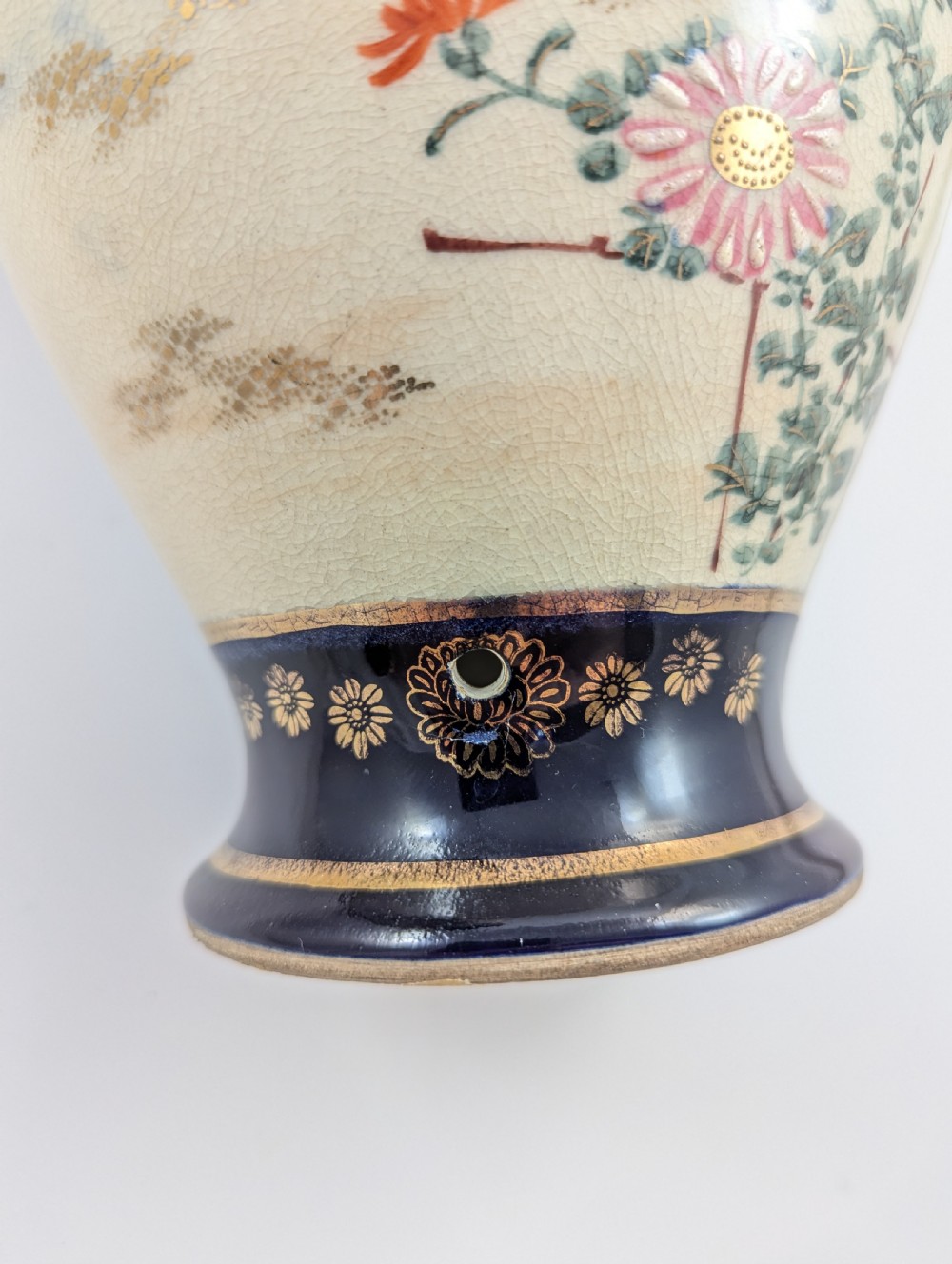 A pair of Japanese Satsuma baluster vases featuring painted figures in a snowy landscape framed by cobalt blue and gilded borders. View XI