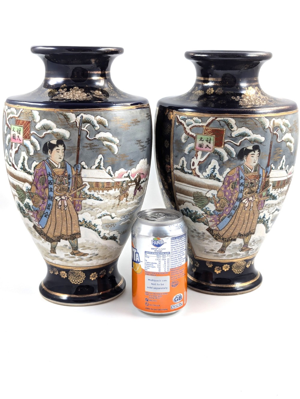 A pair of Japanese Satsuma baluster vases featuring painted figures in a snowy landscape framed by cobalt blue and gilded borders. View XII