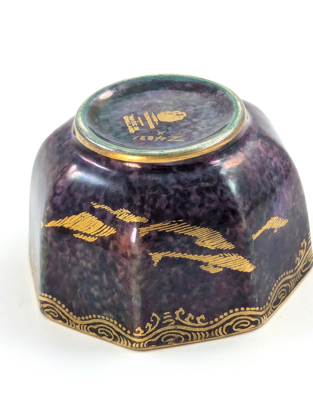 An octagonal Wedgwood Fairyland Lustre porcelain bowl decorated with gilded goldfish motifs over a mottled deep purple exterior and an iridescent pale interior. View X