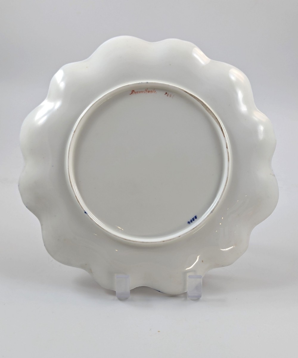 A Victorian Aynsley porcelain cabinet plate featuring a central hand-painted landscape surrounded by a scalloped cobalt blue border with intricate gold leaf ornamentation. View VI