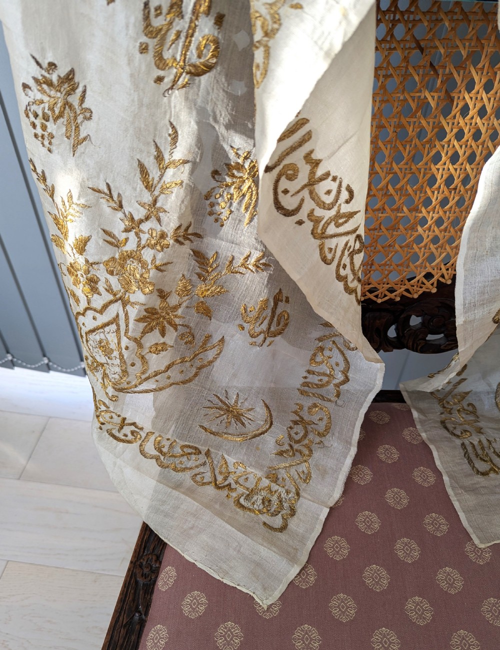 A light cream silk scarf featuring metallic gold thread hand embroidery with floral motifs, crescent symbols, and calligraphic borders. View V